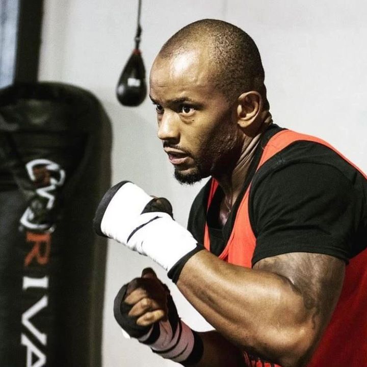 “Big Mitch”, boxing and MMA coach, throwing a punch at the heavy bag